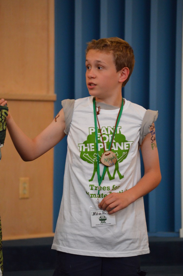 Climate Justice Ambassador Noah Clark giving the Plant for the Planet Slideshow Presentation.jpg